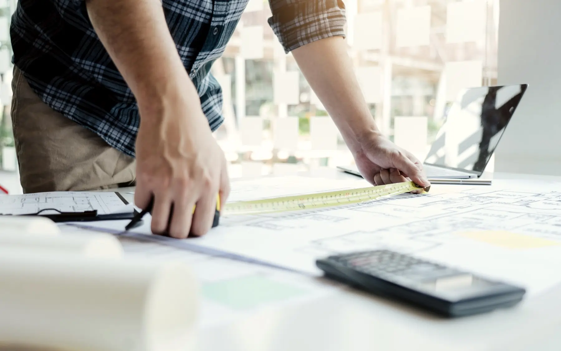 architect measuring blueprint